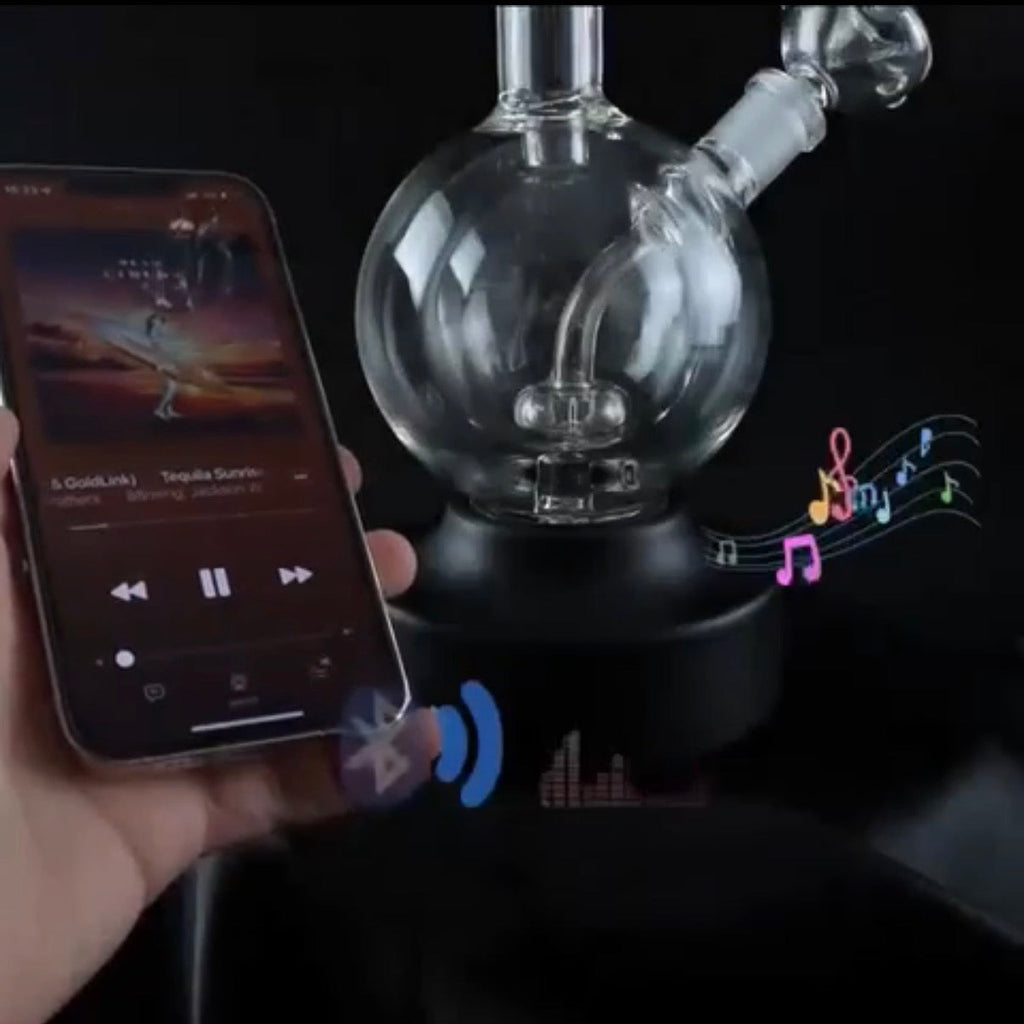 Glass water pipe with smartphone displaying music app and musical notes.