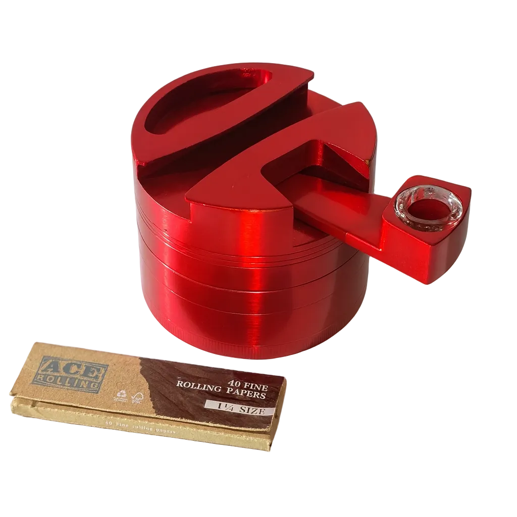 Red metal grinder with a box of rolling papers