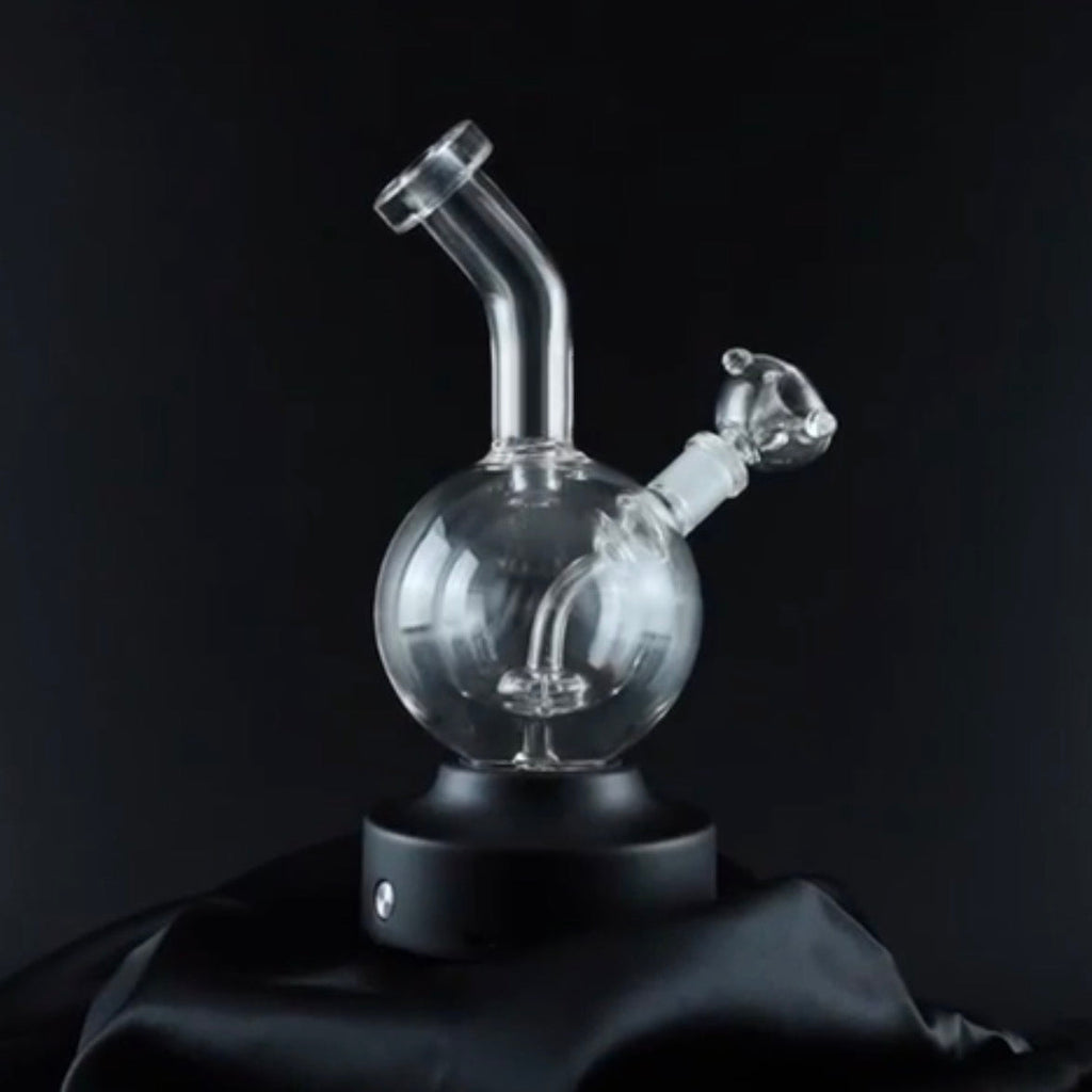 Clear glass smoking device on a black background