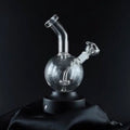 Clear glass smoking device on a black background