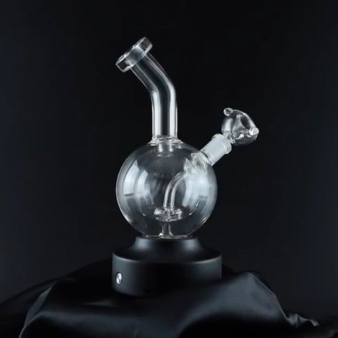 Clear glass smoking device on a black background
